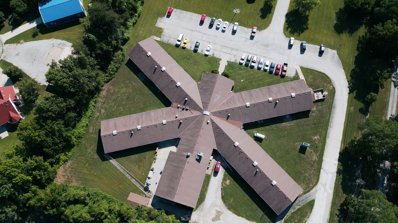 Aerial view of a senior living facility with parking lot