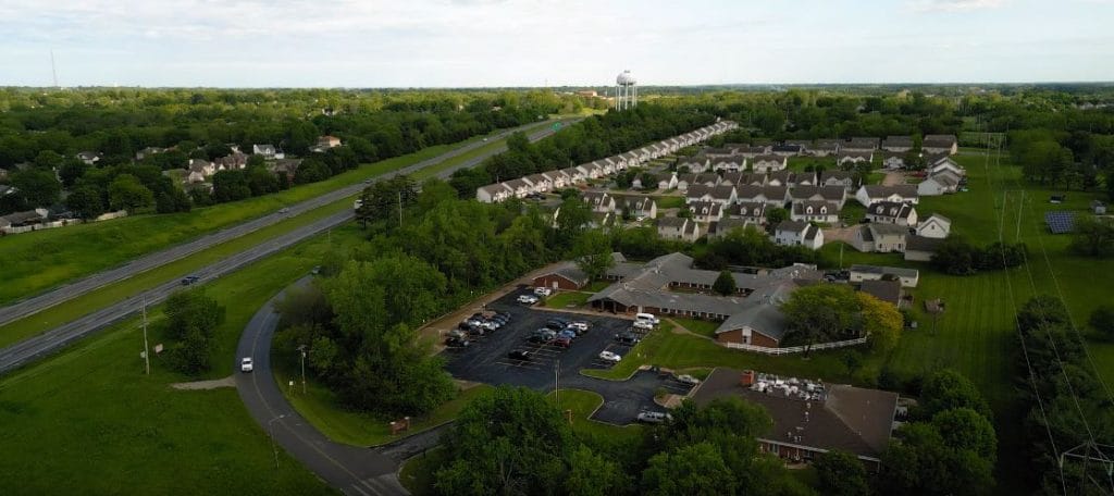 Aerial view of a senior living community with buildings and greenery