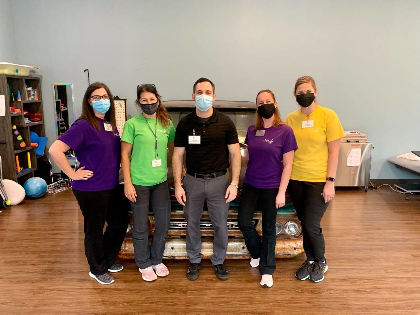 Staff members posing in an activity room