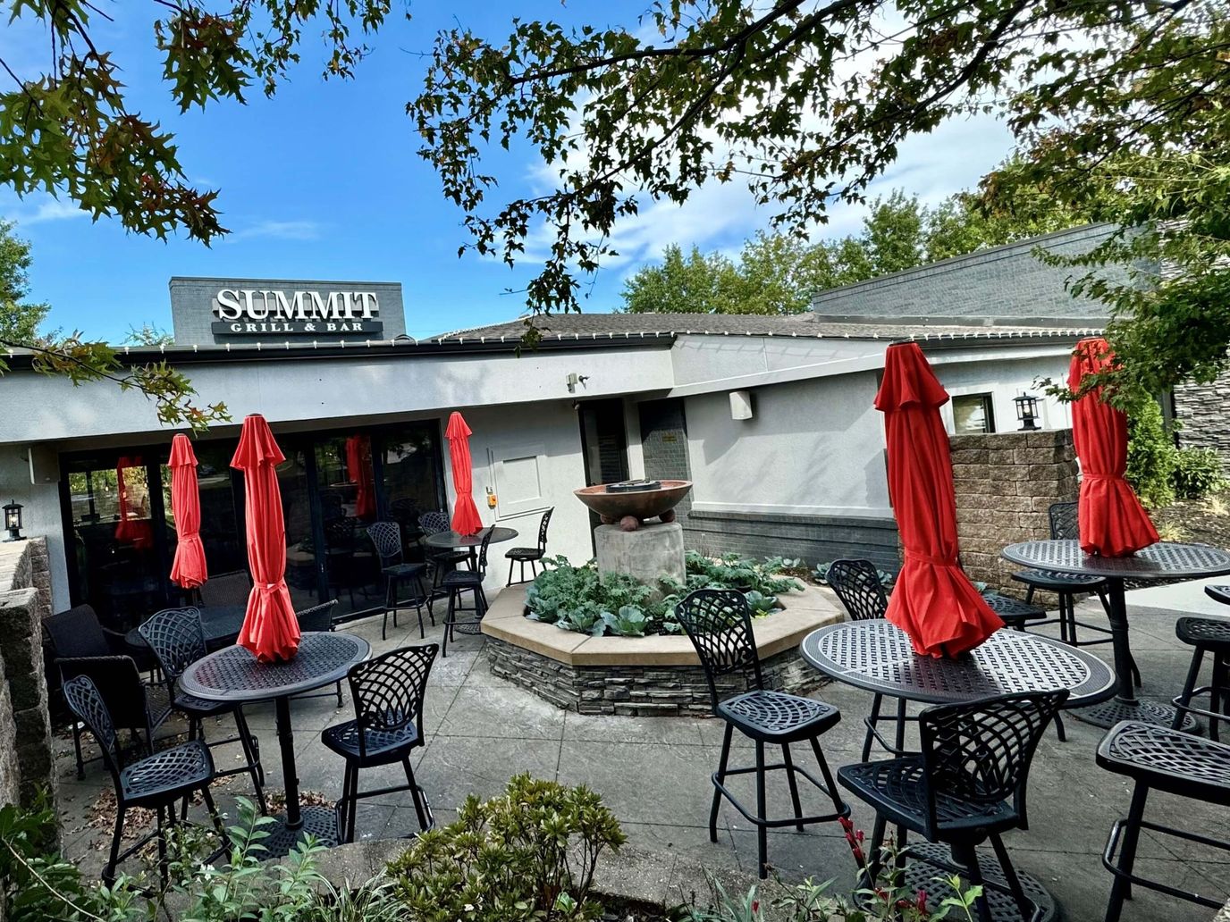 Outdoor dining area with red umbrellas and seating