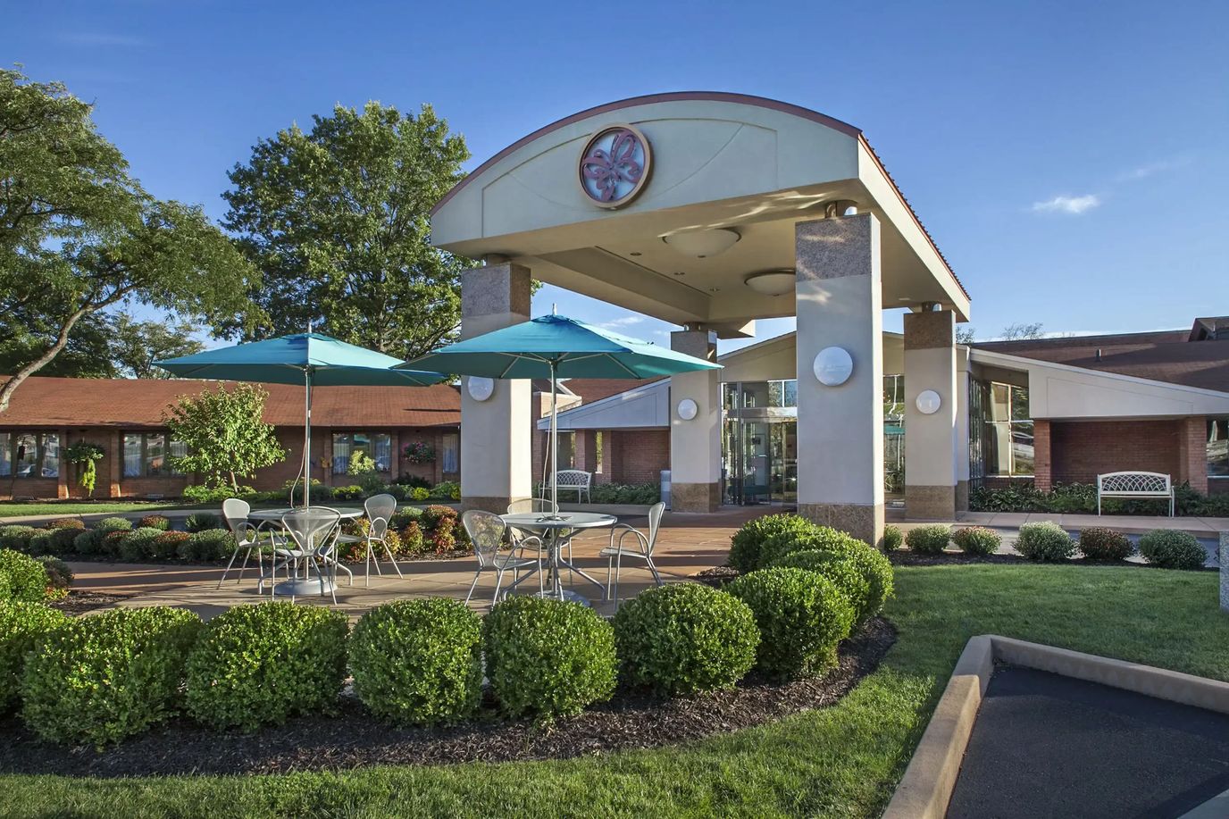 Outdoor seating area in front of a senior living facility