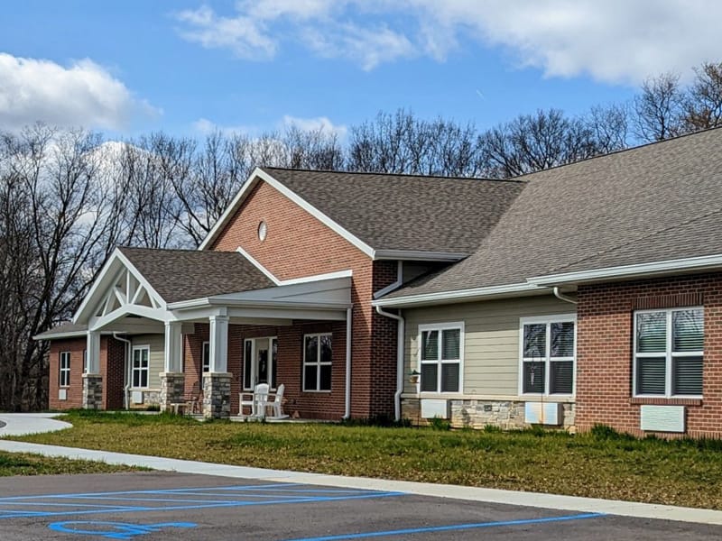 Exterior view of assisted living facility with landscaped entrance