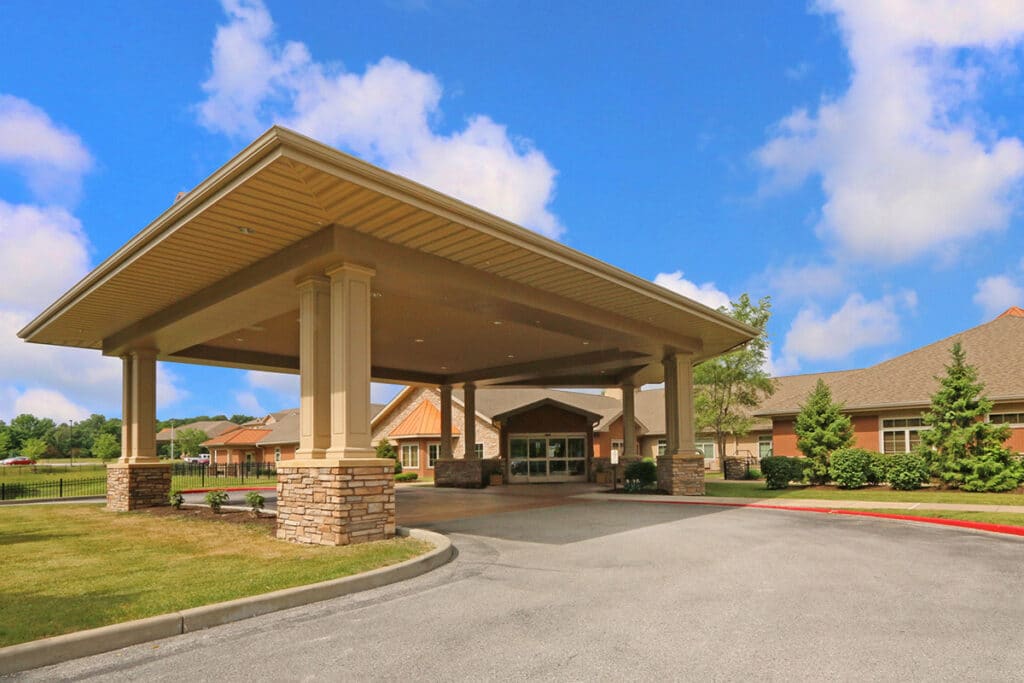 Front entrance of a senior living facility with awning