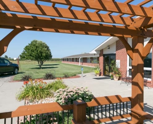Exterior view of a nursing home facility with gardens