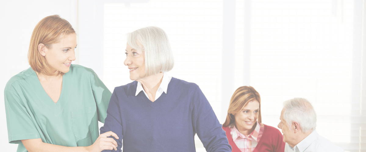 Arbor Care Centers – Ord, LLC, Nursing Home in Ord, NE — Staff assisting residents in a cheerful common area