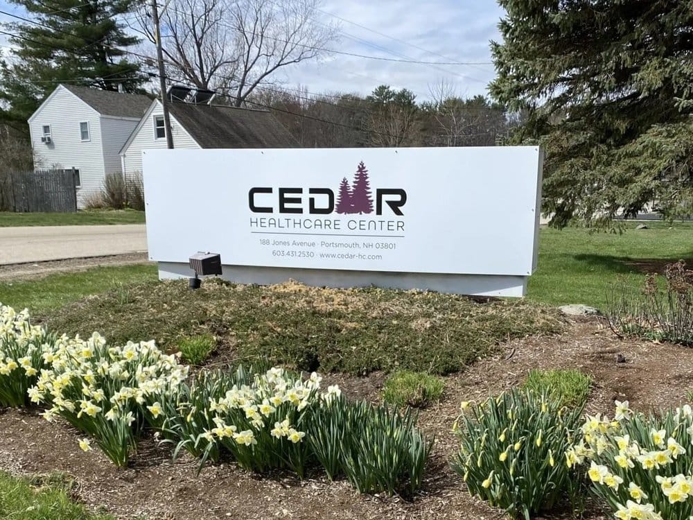 Exterior view of Cedar Healthcare Center sign and landscaping