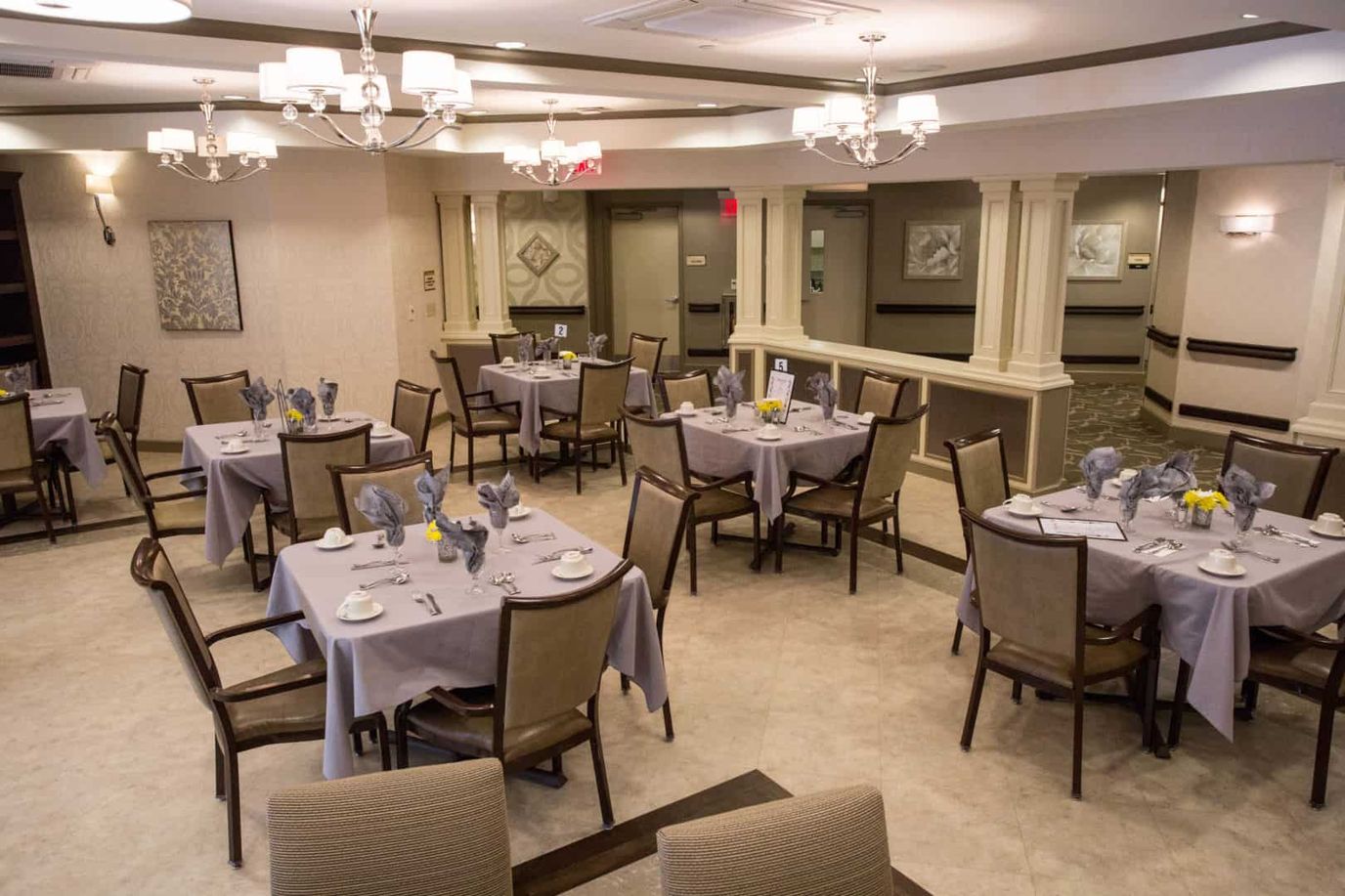 A dining room set up with tables and chairs.