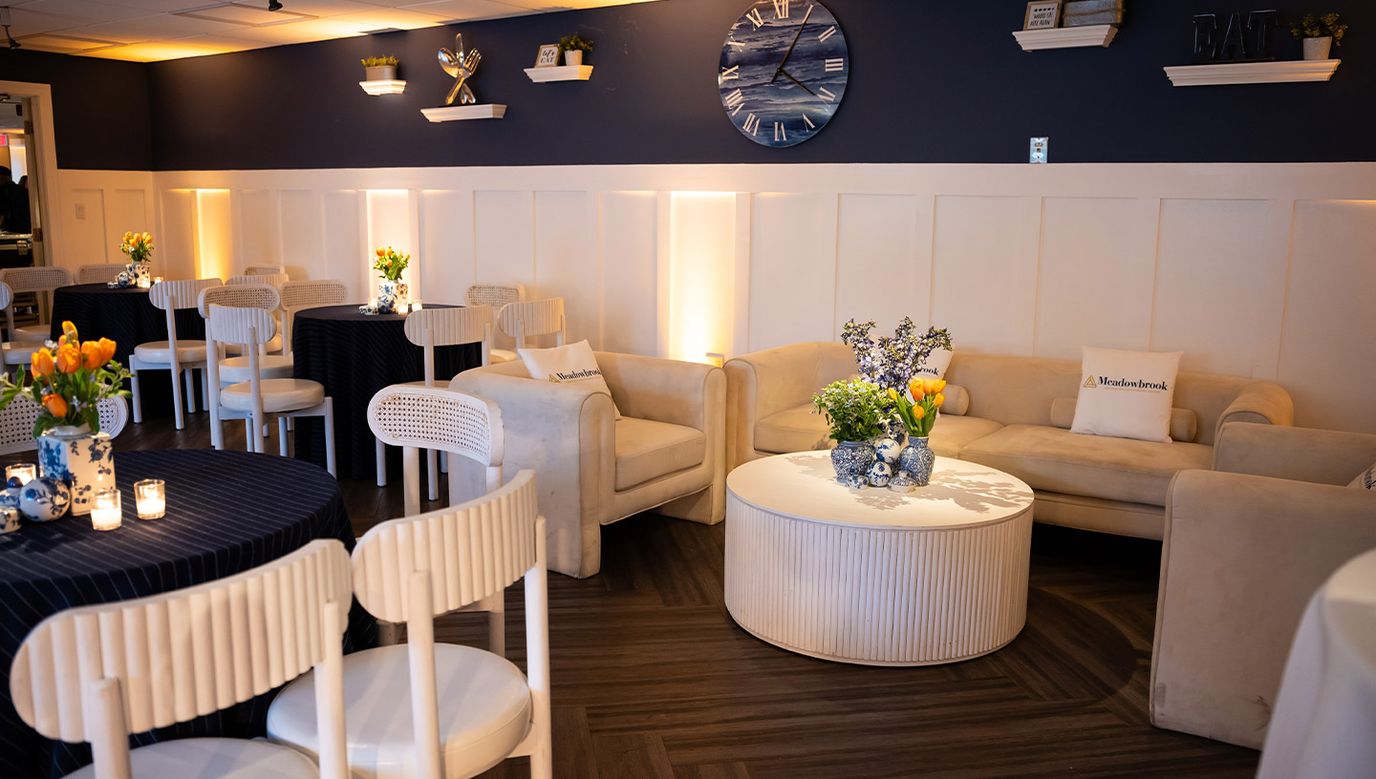 Cozy lounge area with seating and flower arrangements
