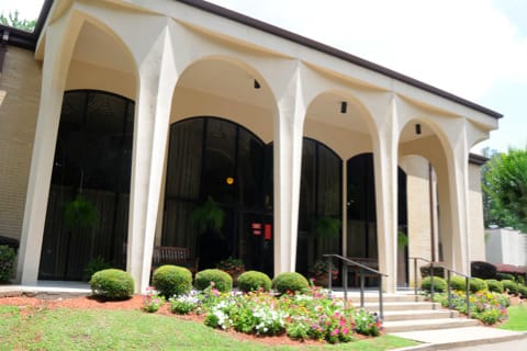 Exterior view of the assisted living facility with landscaped gardens