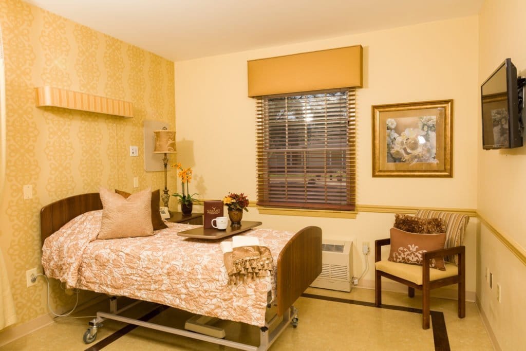 Cozy resident room with a bed and chair