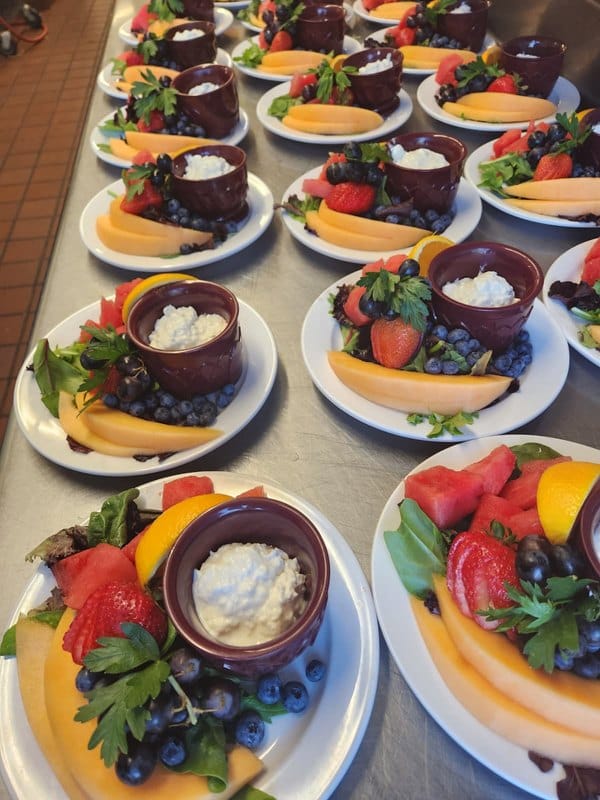 Plates of fruit and dessert presented elegantly