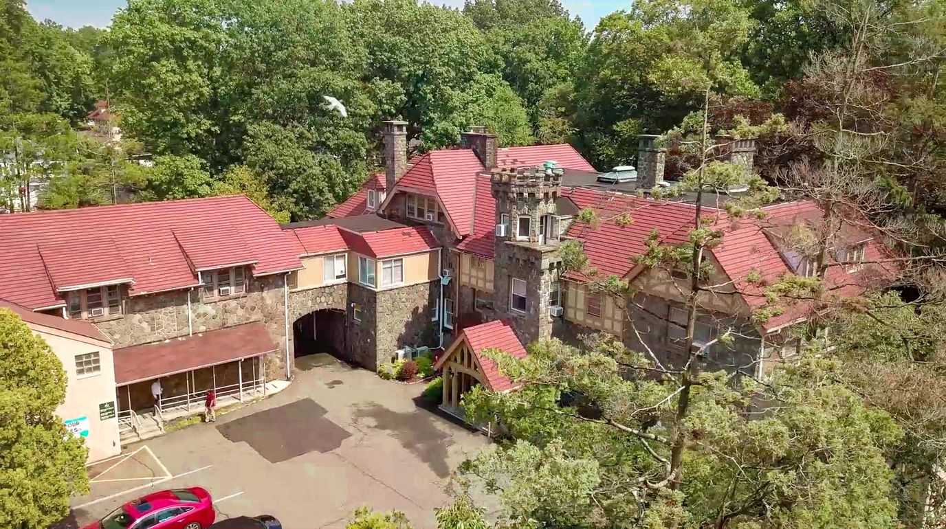 Aerial view of a senior living facility surrounded by trees