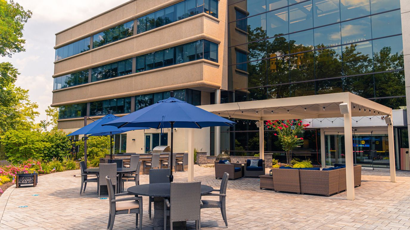 Outdoor seating area with umbrellas beside the facility