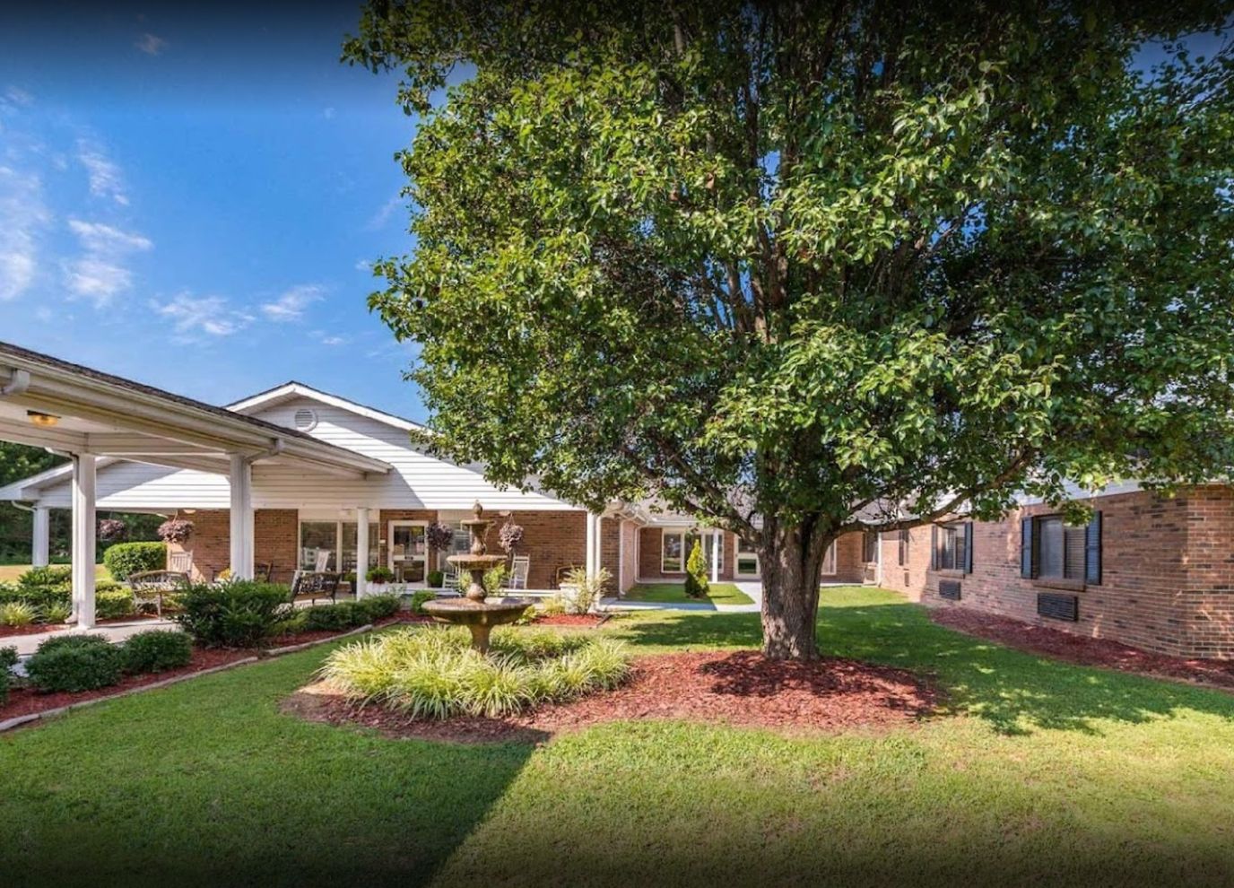 Exterior view of the assisted living facility with gardens