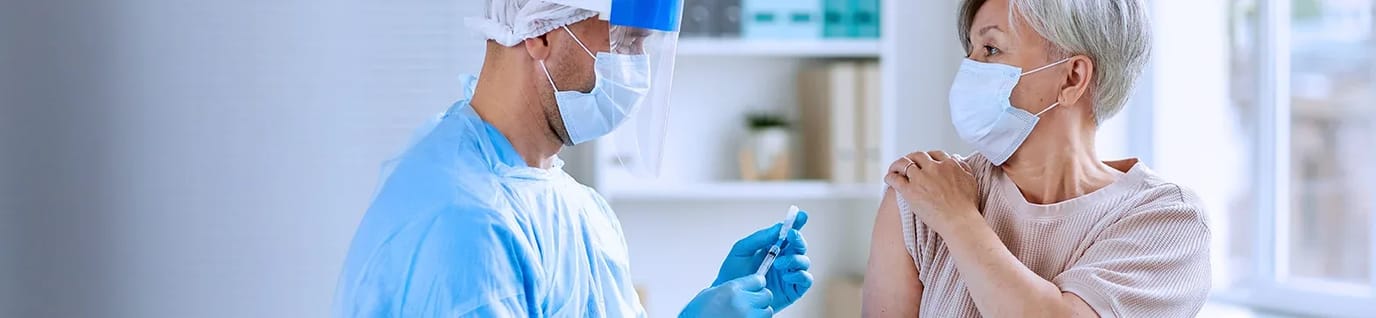 Onondaga Center for Rehabilitation and Nursing, Nursing Home in Minoa, NY — Healthcare worker administering a vaccine to a senior