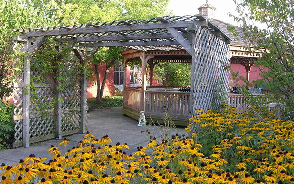 Garden gazebo surrounded by vibrant flowers