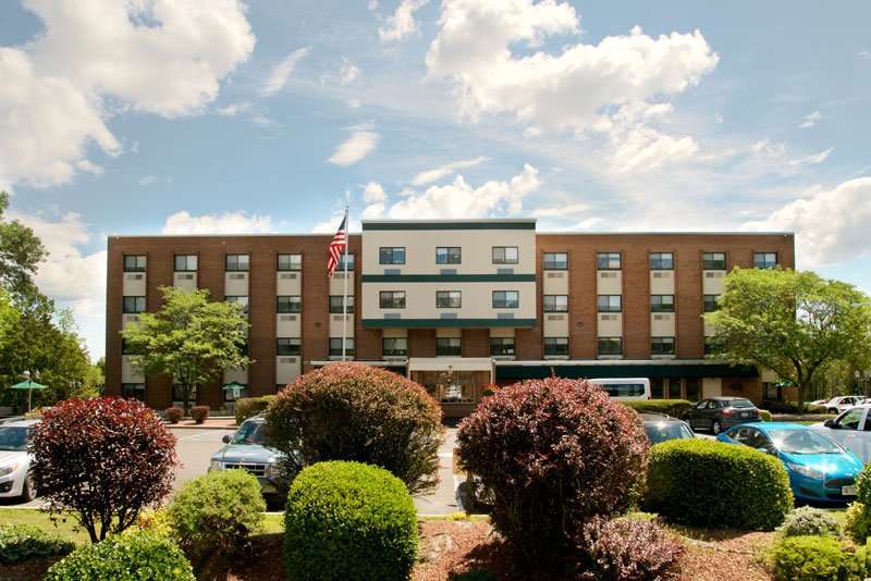 Exterior view of a senior living facility with landscaping