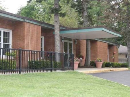 Exterior view of a senior living facility with landscaping