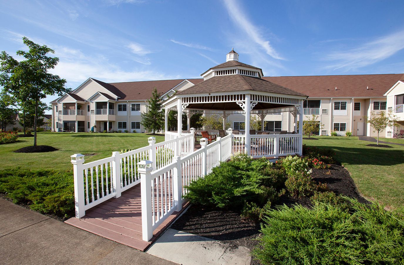 Exterior view of a senior living facility with garden