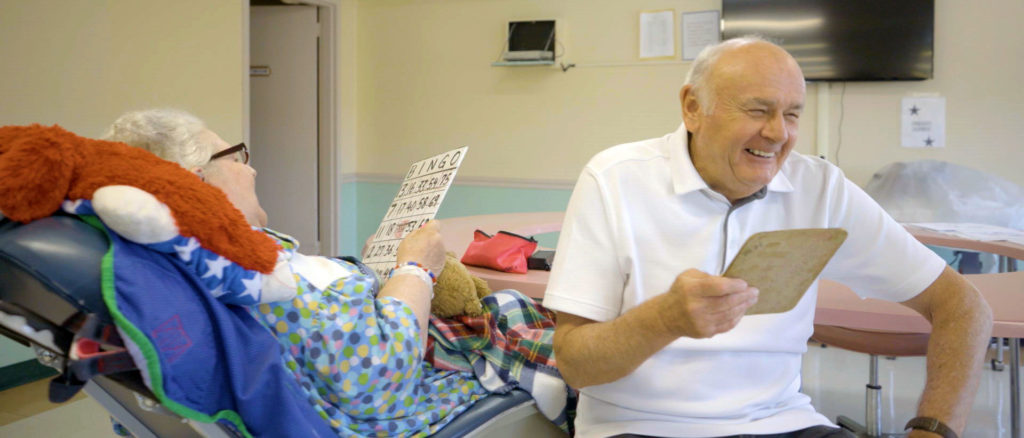 Residents enjoying a bingo game in a common area