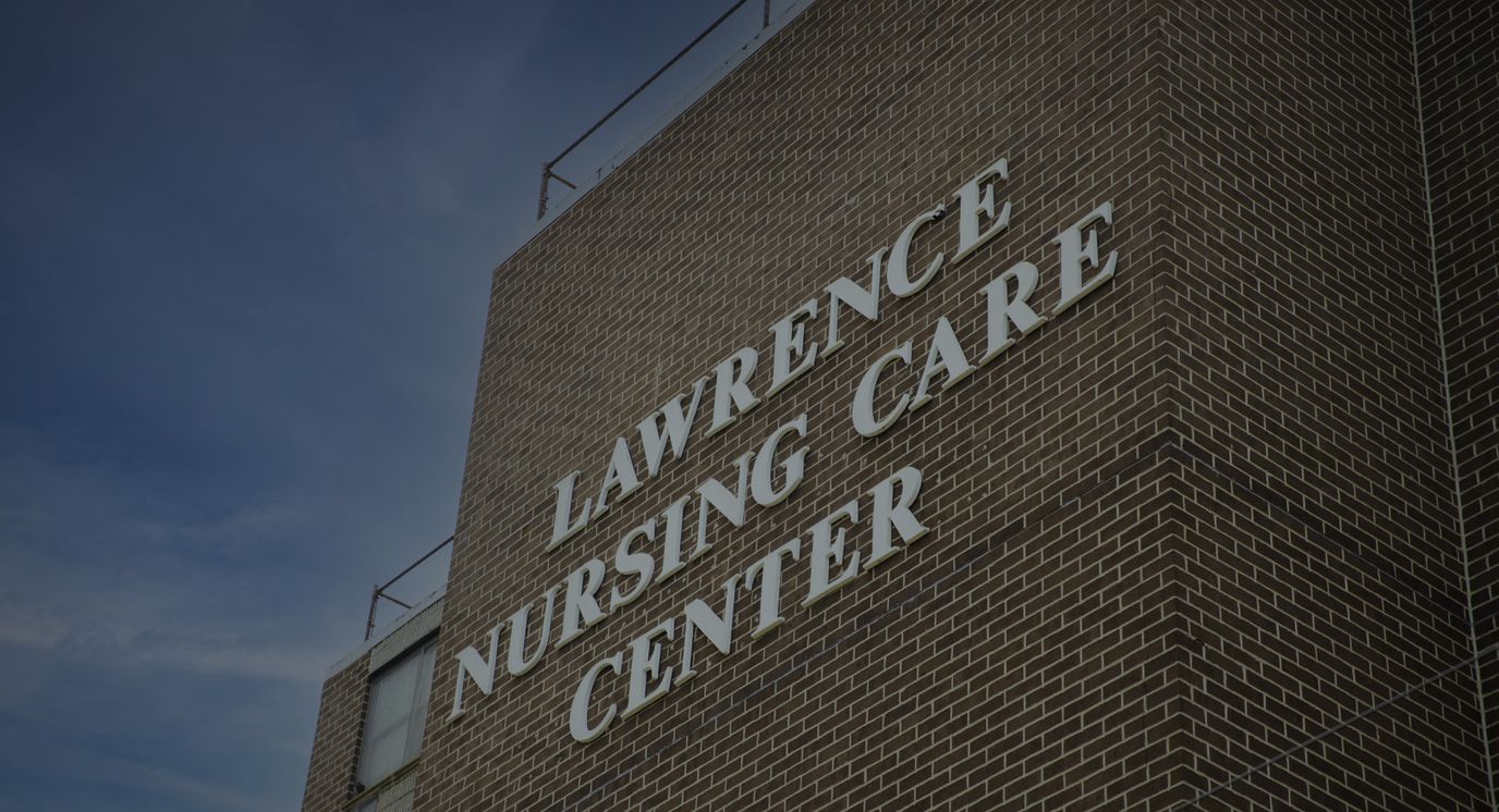 Close-up of Lawrence Nursing Care Center sign on building