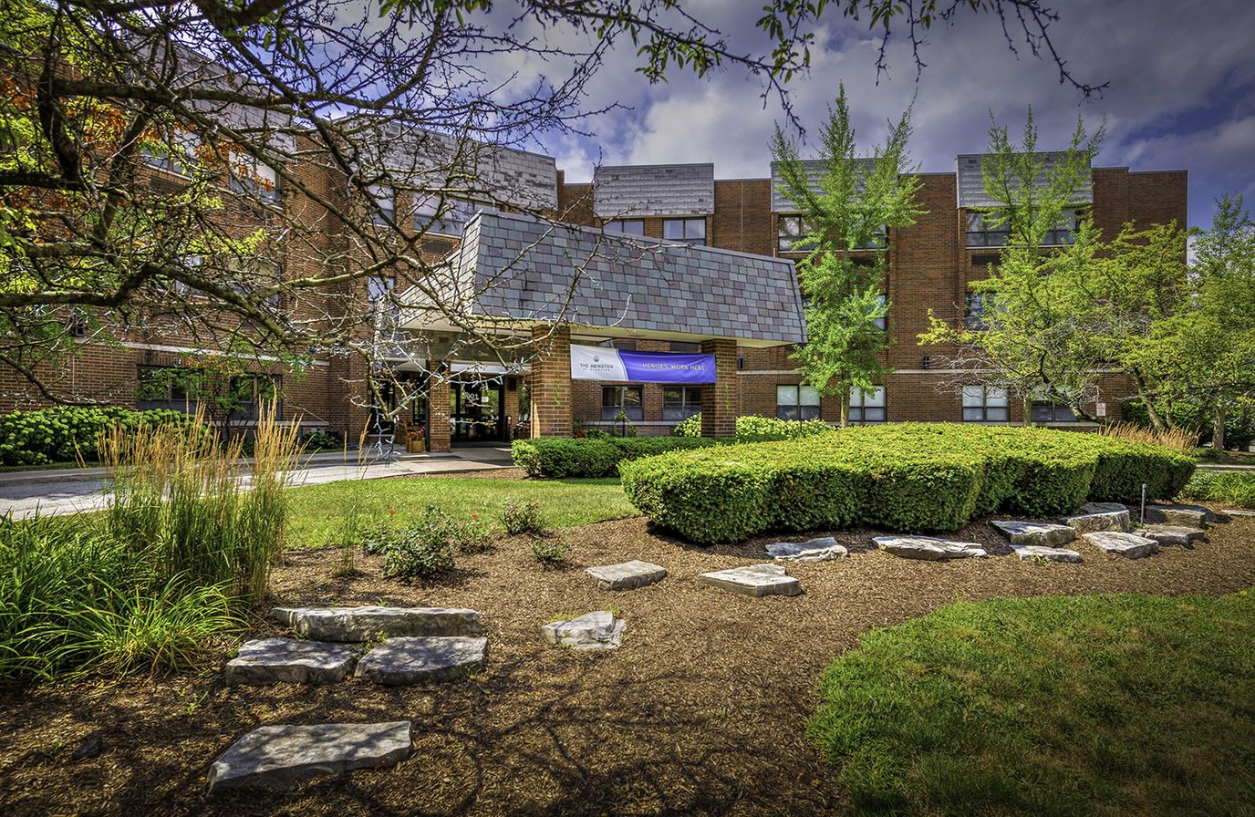Exterior view of a senior living facility with lush landscaping