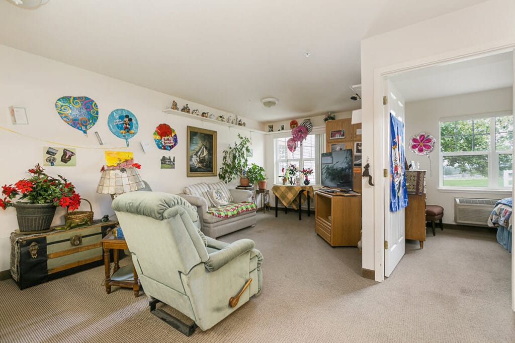 A cozy resident room decorated with balloons and plants