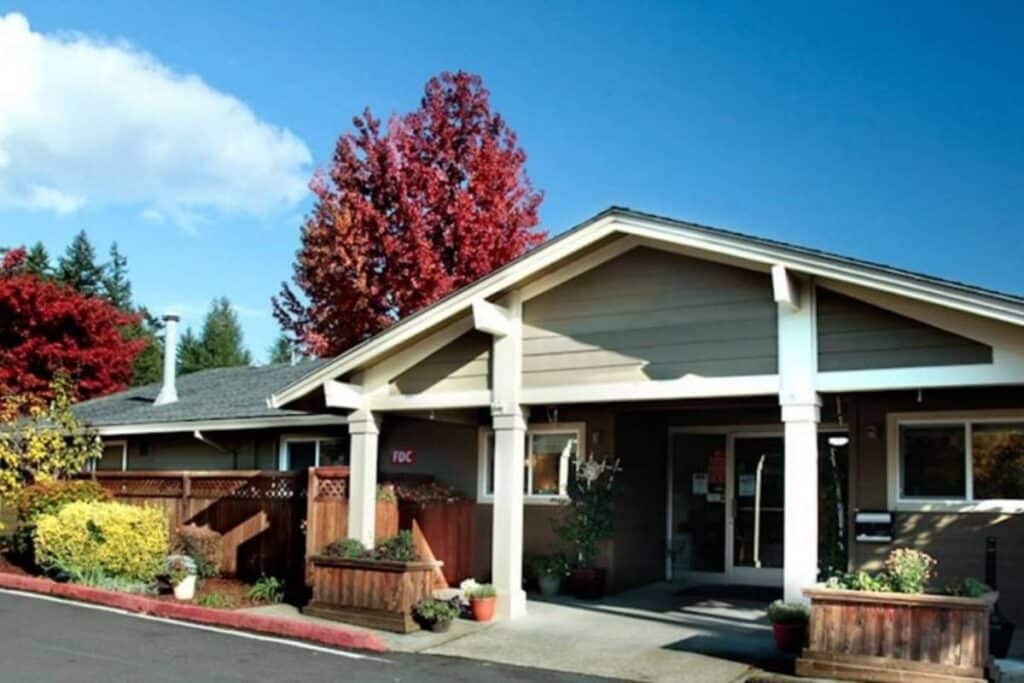 Exterior view of a senior living facility with colorful trees
