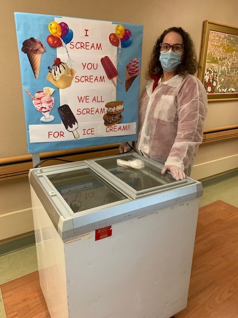 Staff member serving ice cream in a common area