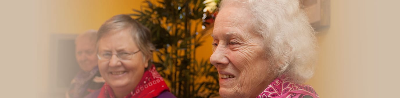 Two smiling residents in a common area