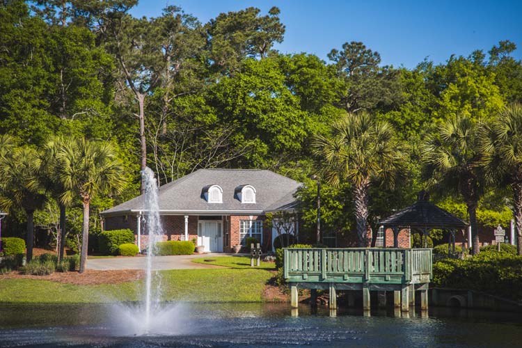 Beautiful outdoor view of assisted living facility with fountain