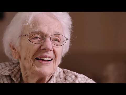 NHC Healthcare Murfreesboro, assisted living in Murfreesboro, TN — Smiling elderly woman with glasses in a cozy setting