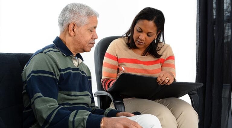 A staff member assisting a resident in a facility