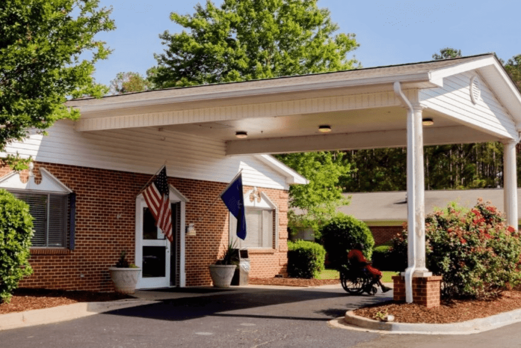 Front entrance of a senior living facility with flags