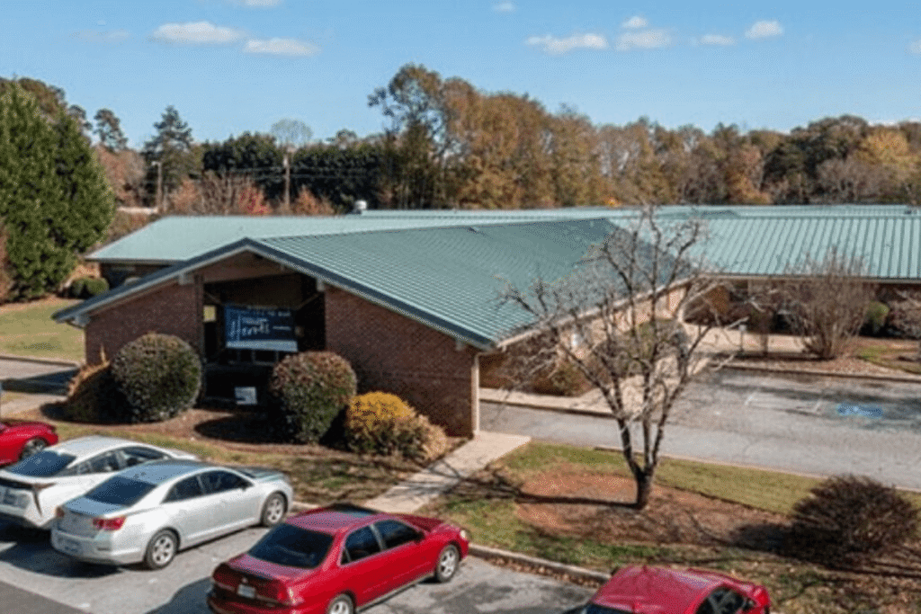 Exterior view of a senior living facility with parking