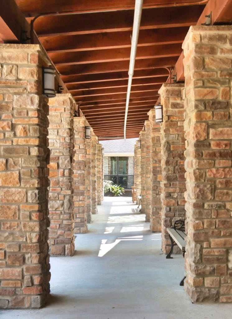 Interior corridor with stone columns and natural light