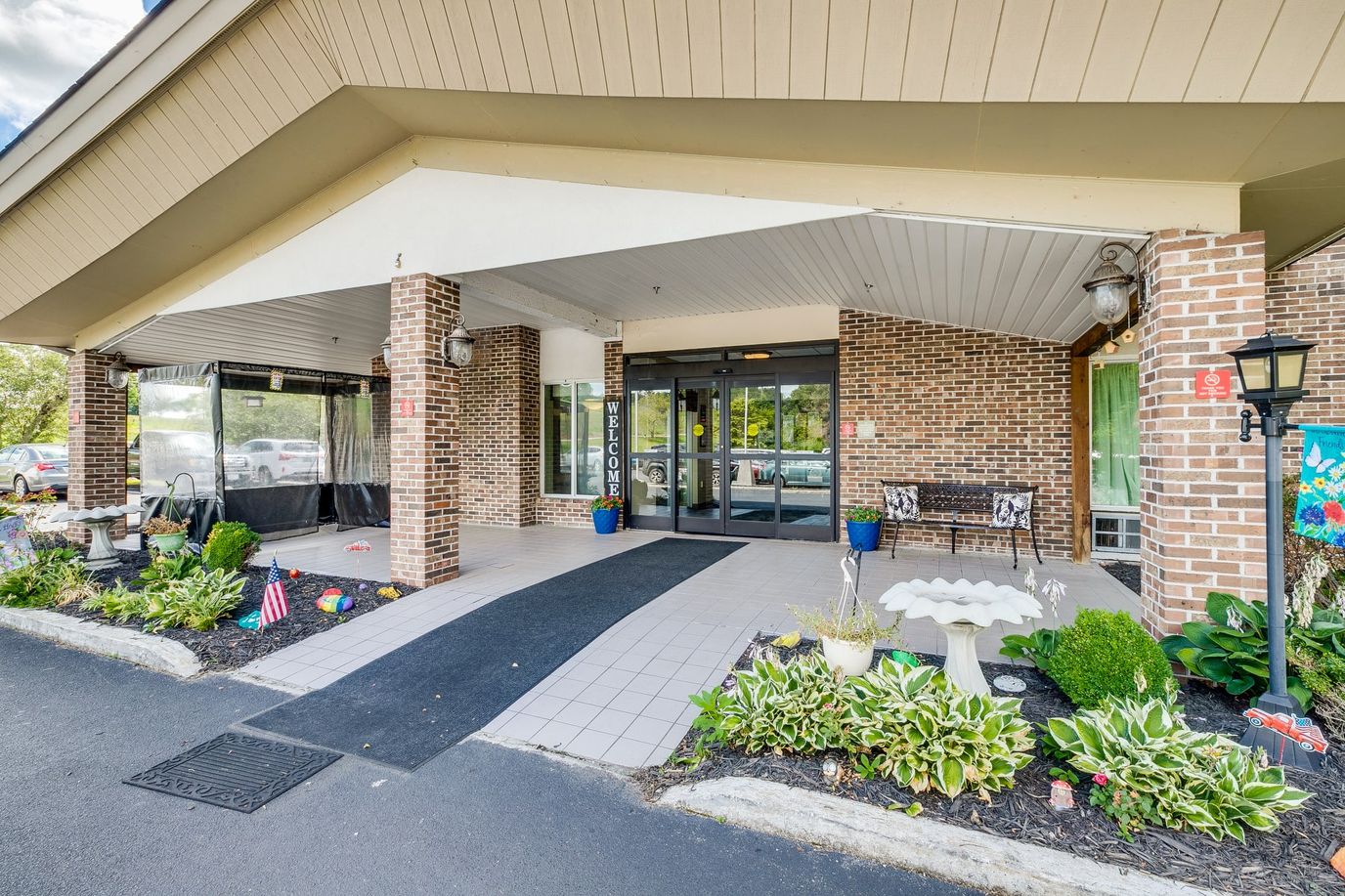 Entrance of a senior living facility with landscaping
