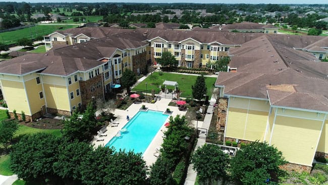 Aerial view of a senior living campus with pool.