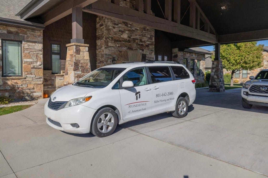 Facility transport van parked outside the entrance