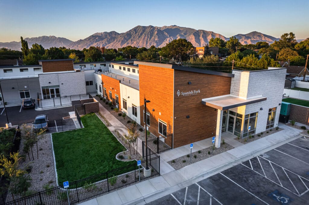 Aerial view of a senior living facility with mountains in the background