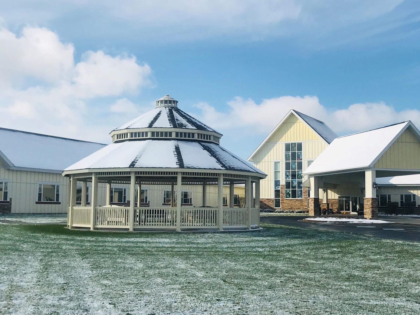 Exterior view of a senior living facility with a gazebo