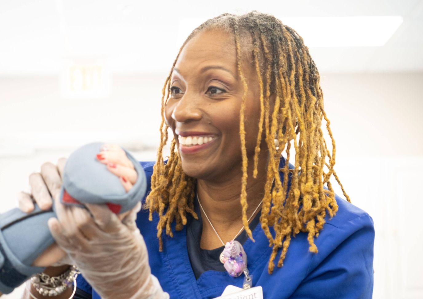 A staff member smiling while assisting a resident