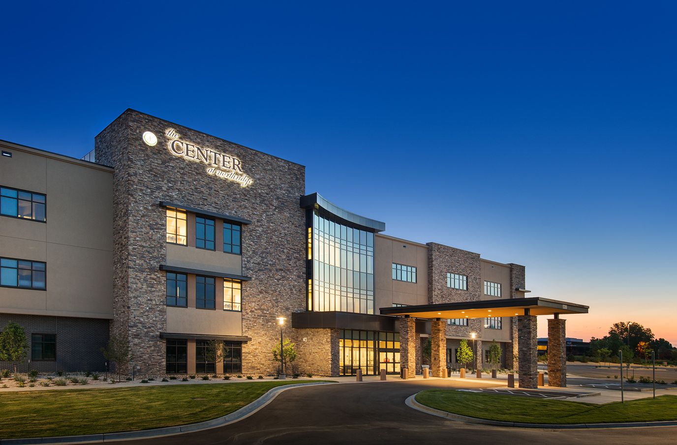 Exterior view of a modern senior living facility at dusk