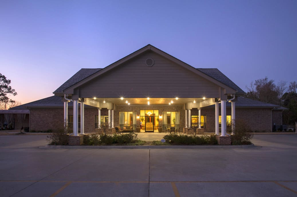 Exterior view of a senior living facility at dusk