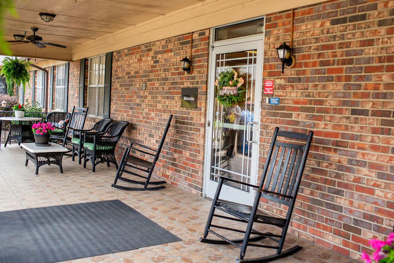 Exterior view of a welcoming entrance with rocking chairs