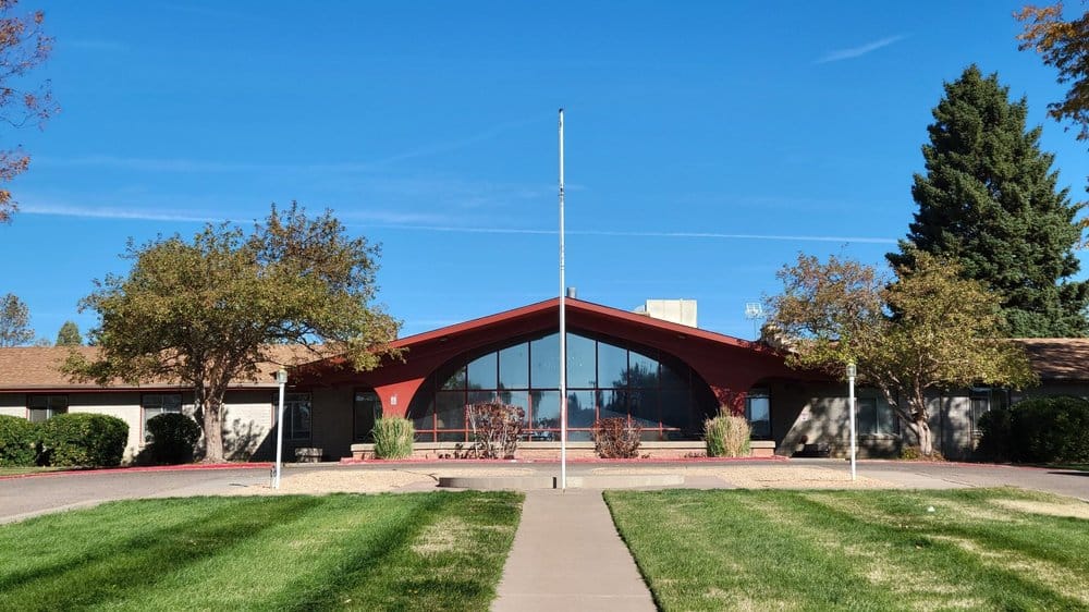 Front view of a senior living facility under clear blue sky