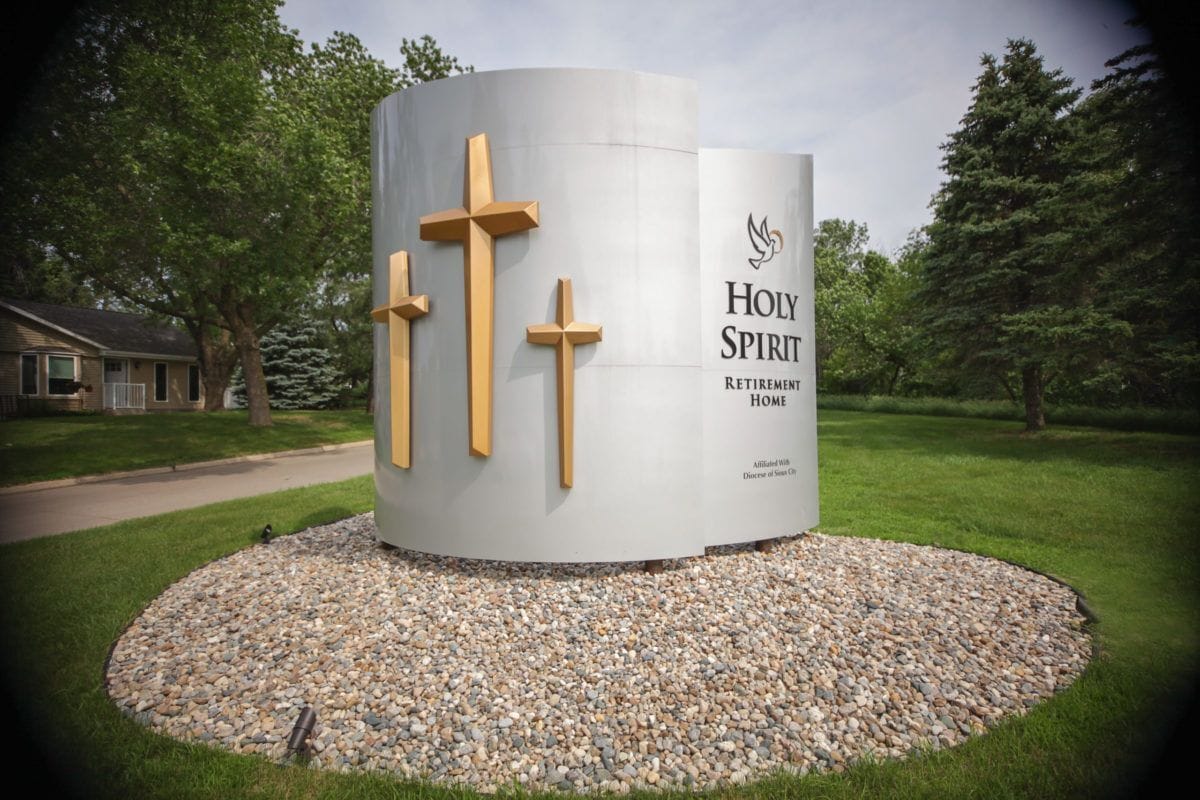 Sign for Holy Spirit Retirement Home surrounded by greenery
