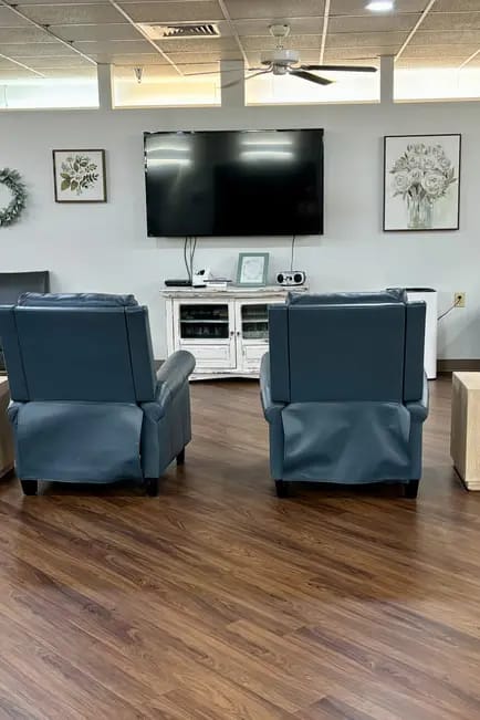 Cozy common area with recliners and a TV