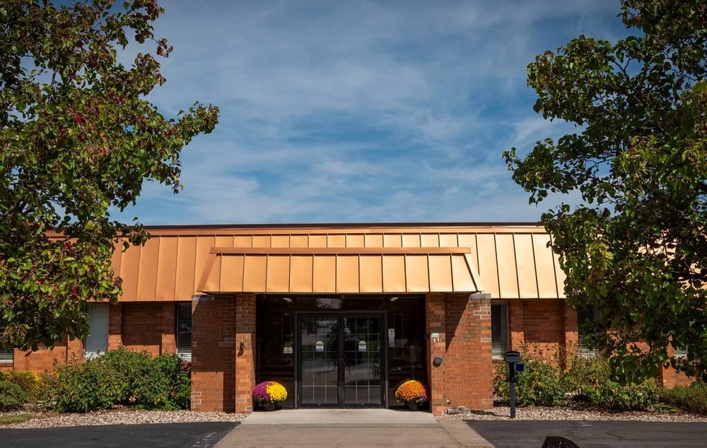 Exterior view of a senior living facility with landscaping