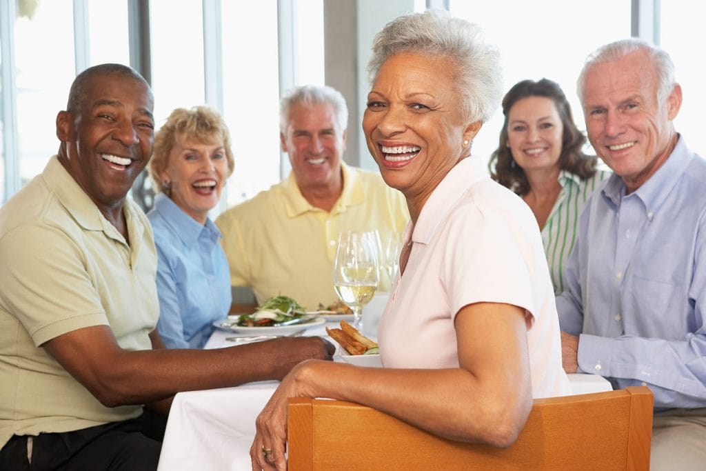 Seniors enjoying a meal together in a dining area.